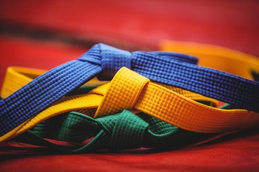 Close-up of blue, yellow and green karate belt