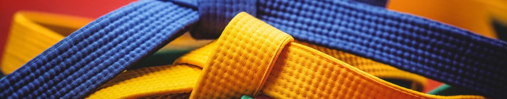 Close-up of blue, yellow and green karate belt